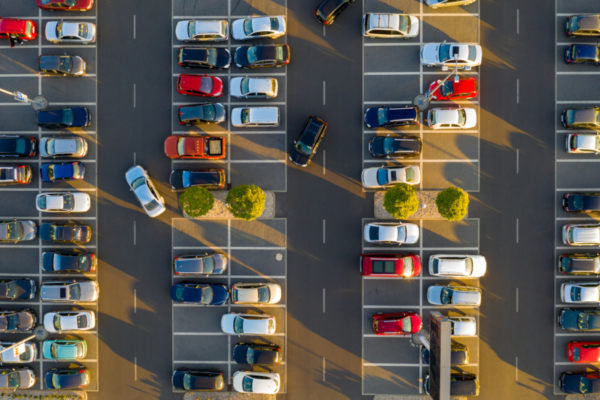 Top down view from drone on mall parking with many cars.|Top down view from drone on mall parking with many cars.