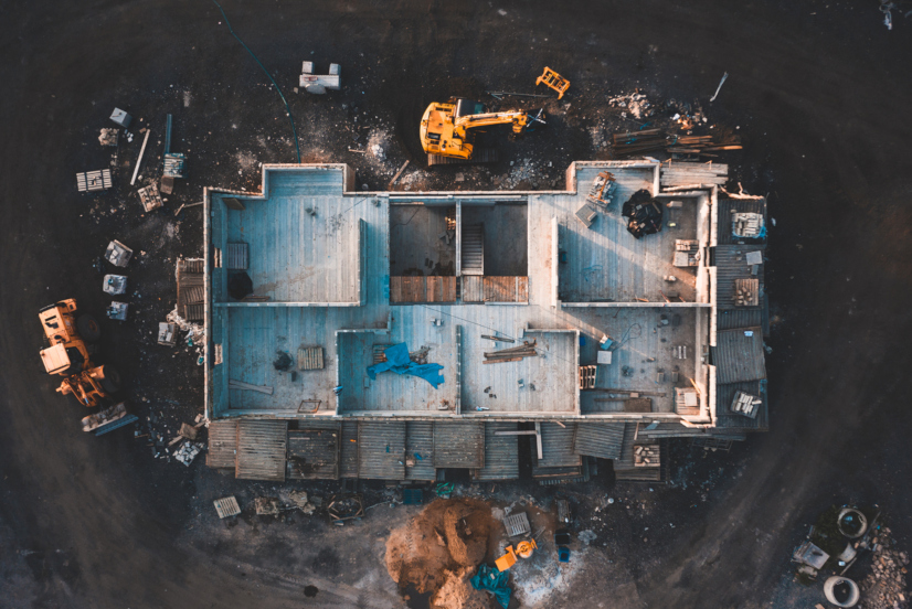 Drone footage of the inside of a house under construction surrounded by building equipment taken at sunrise in spring 2019