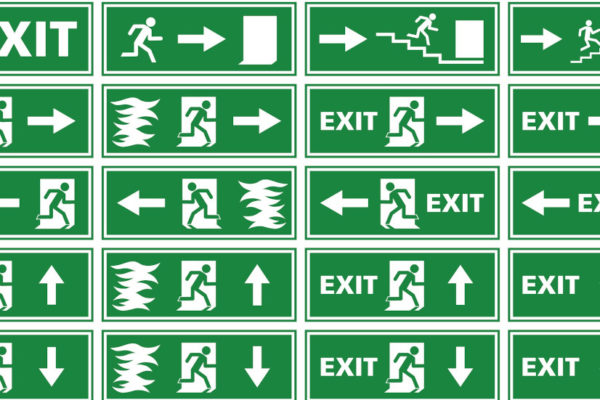A collection of different variations of emergency exit signs / plates showing white silhouettes on green background. Various illustrations of a person or man running toward an exit door of a building to escape and find rescue