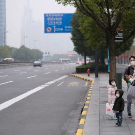 Shanghai/China-Jan.2020: New type coronavirus pneumonia in Wuhan has been spreading into Shanghai. A family wearing surgical mask waiting at bus station