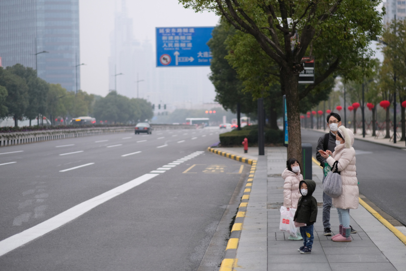 Shanghai/China-Jan.2020: New type coronavirus pneumonia in Wuhan has been spreading into Shanghai. A family wearing surgical mask waiting at bus station