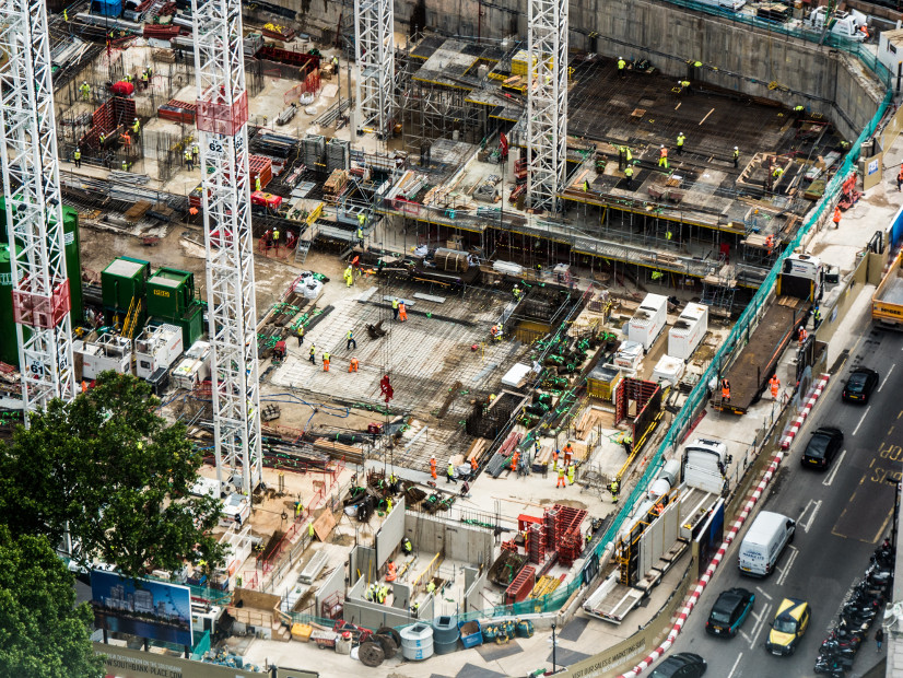 An aerial view of a major construction project in London, with cranes and other construction machinery visible.